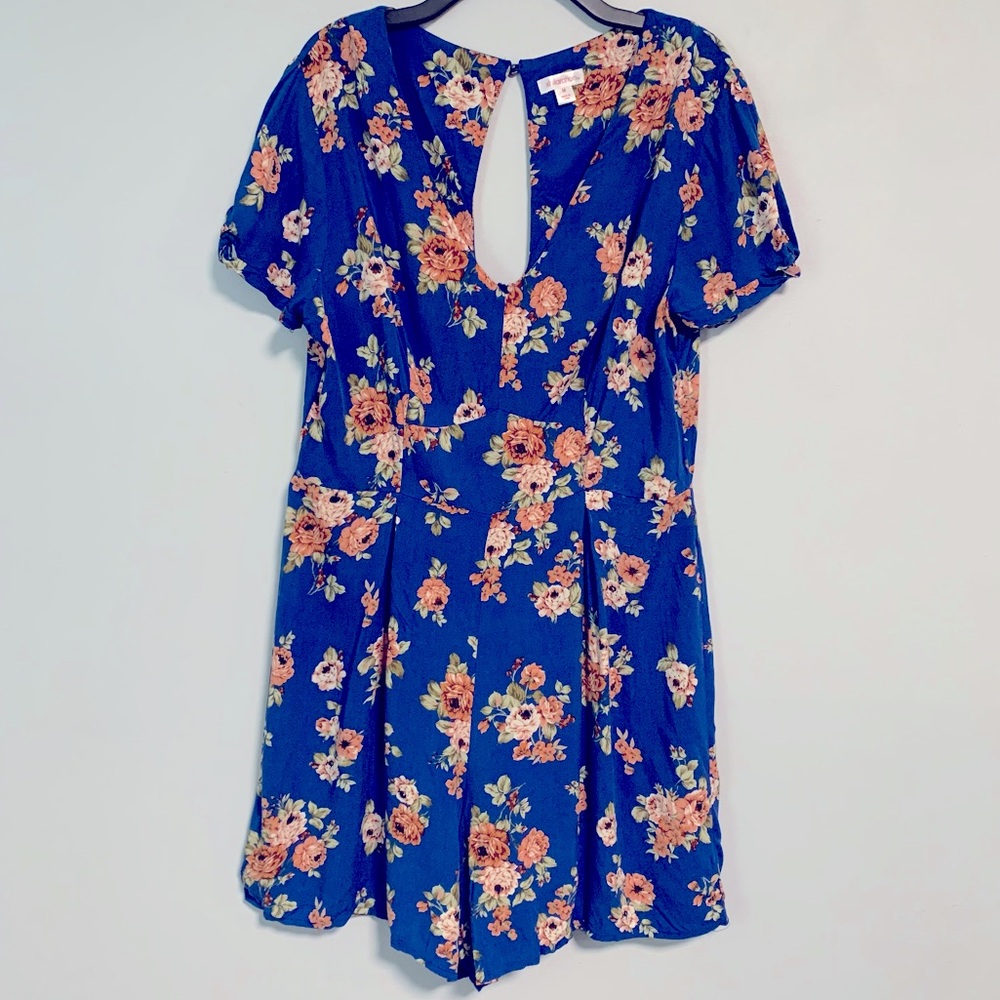 Blue floral romper jumpsuit size medium with pockets ruffle trim shorts